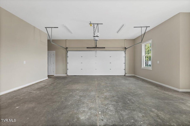 garage with a garage door opener and baseboards