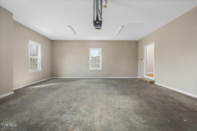 garage featuring a garage door opener and baseboards