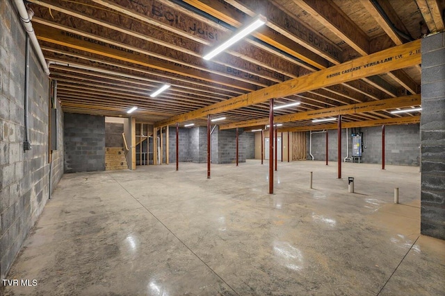 unfinished basement featuring electric water heater