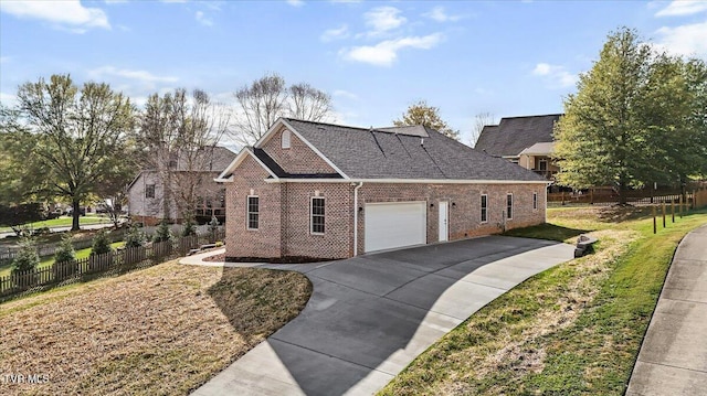 view of home's exterior featuring brick siding, concrete driveway, a lawn, fence, and a garage