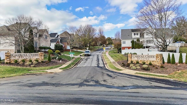 view of road featuring sidewalks, a residential view, and curbs