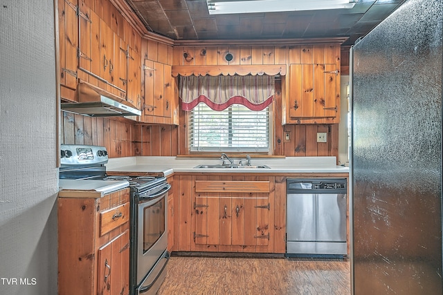 kitchen with exhaust hood, ornamental molding, dark hardwood / wood-style floors, sink, and stainless steel appliances