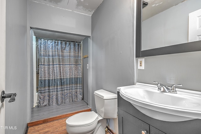 bathroom featuring vanity, hardwood / wood-style flooring, toilet, and a shower with shower curtain