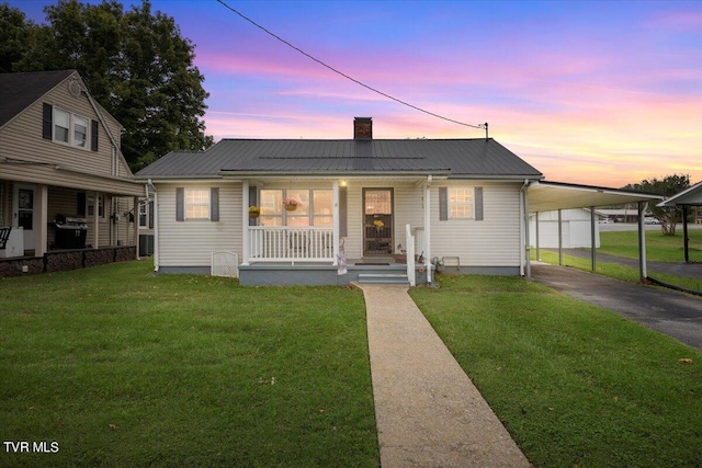 1312 Happy Valley St, Elizabethton, TN 37643 - view of front of house featuring driveway, a front yard, covered porch, and a chimney