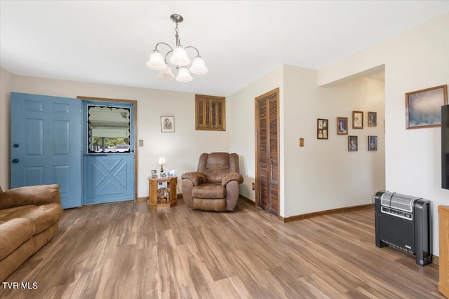 sitting room featuring a chandelier and wood-type flooring