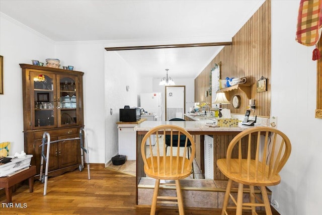 1312 Happy Valley St, Elizabethton, TN 37643 - kitchen featuring black microwave, wood finished floors, freestanding refrigerator, a notable chandelier, and ornamental molding
