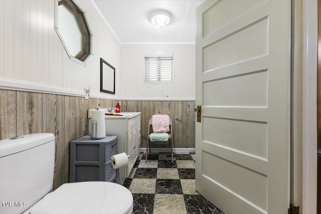 1312 Happy Valley St, Elizabethton, TN 37643 - bathroom featuring vanity, wood walls, crown molding, toilet, and a wainscoted wall