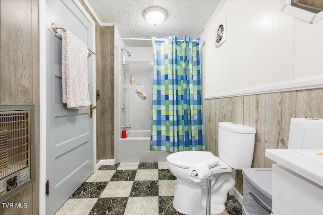 full bathroom with a textured ceiling, shower / bath combo, toilet, wooden walls, and vanity