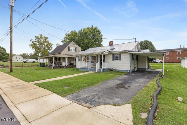 view of front of property with a porch, a front lawn, and a carport