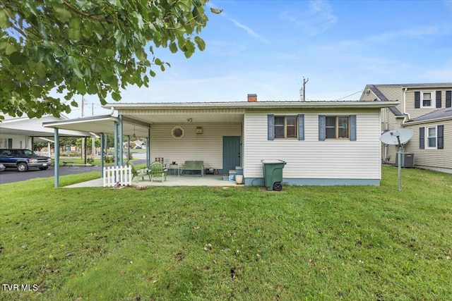 1312 Happy Valley St, Elizabethton, TN 37643 - back of property with a lawn, a patio, an attached carport, and cooling unit