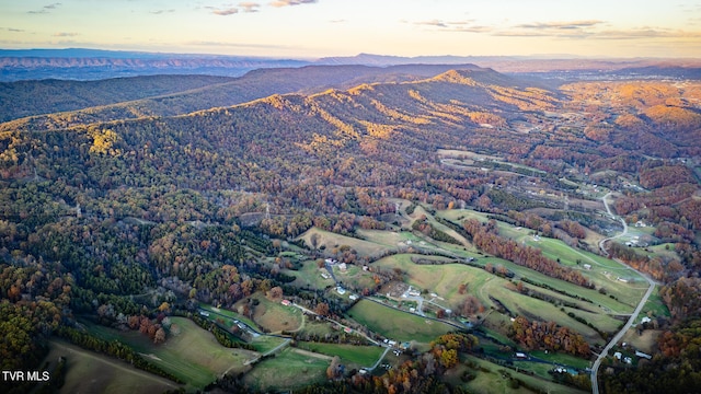 aerial view at dusk featuring a mountain view