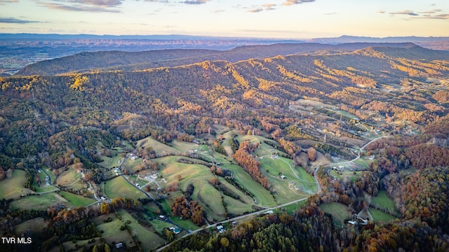 aerial view at dusk featuring a mountain view