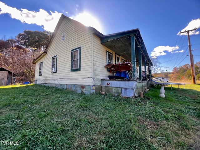 view of side of property with a yard and a trampoline