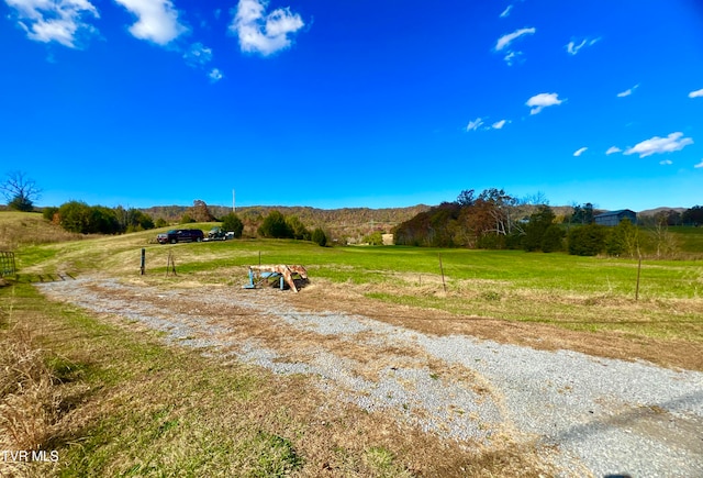 view of yard with a rural view