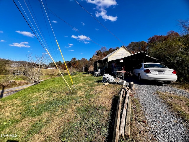 view of property exterior with a yard and a carport