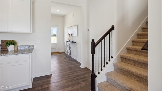 interior space featuring baseboards and wood finished floors