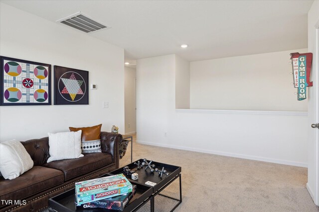 carpeted living area featuring recessed lighting, visible vents, and baseboards