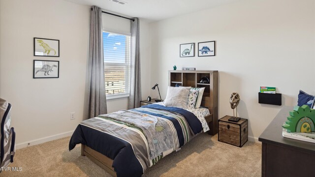 carpeted bedroom featuring visible vents and baseboards