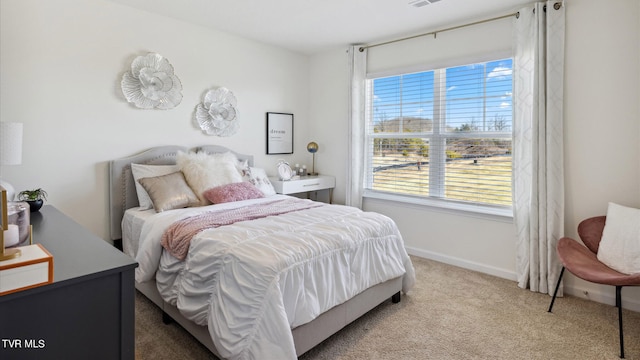 carpeted bedroom with visible vents and baseboards