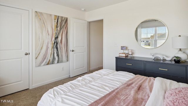 bedroom with carpet floors and baseboards