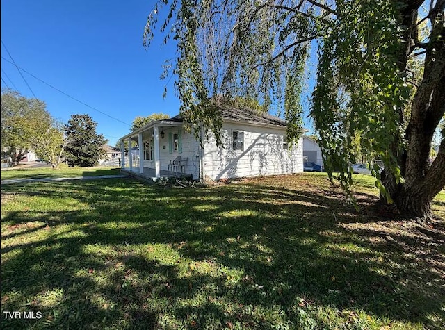 view of side of home with a lawn