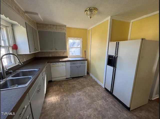 kitchen with white appliances, sink, backsplash, a textured ceiling, and ornamental molding