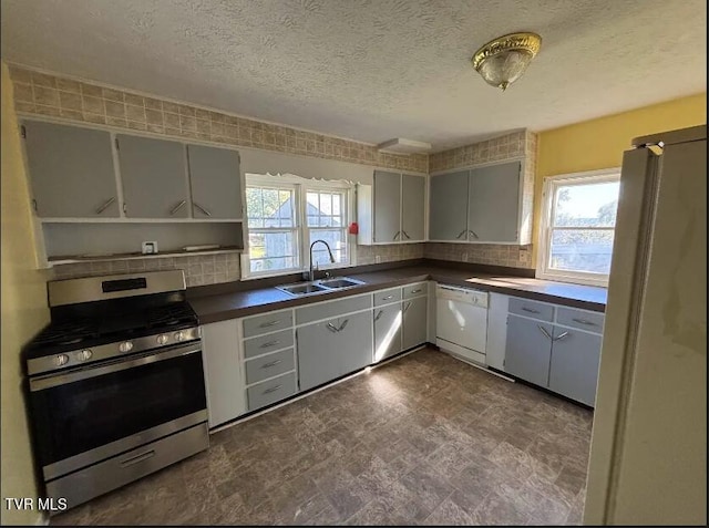 kitchen with sink, decorative backsplash, white appliances, and plenty of natural light