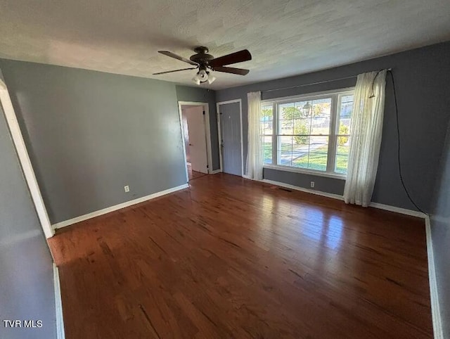 spare room featuring ceiling fan, a textured ceiling, and dark hardwood / wood-style flooring