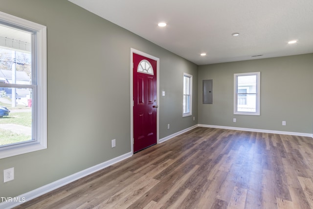 foyer entrance with electric panel and wood-type flooring