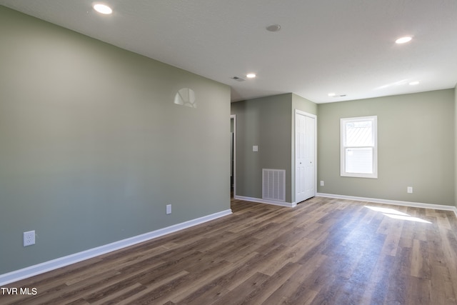 spare room featuring dark hardwood / wood-style floors