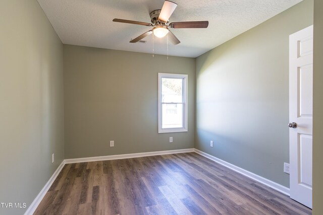 1608 E Fairview Ave, Johnson City, TN 37601 - spare room with baseboards, a ceiling fan, dark wood-type flooring, and a textured ceiling