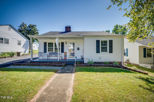 bungalow with a front yard and a porch