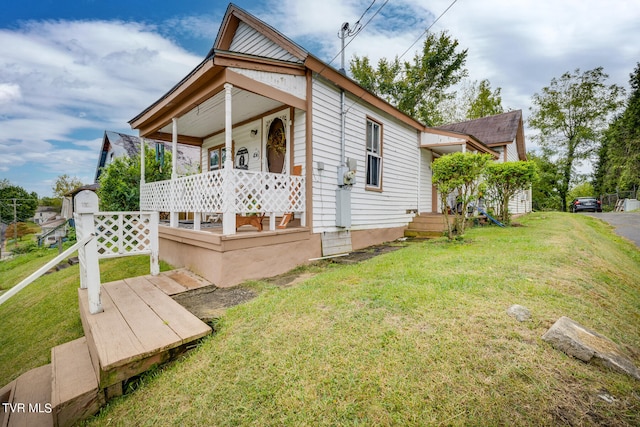 exterior space featuring covered porch and a lawn