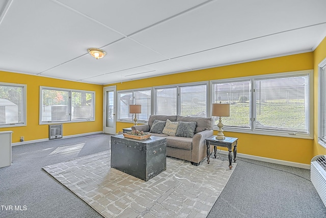 living area with light carpet and baseboards