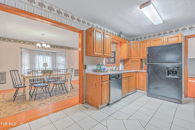 kitchen featuring an inviting chandelier, light countertops, visible vents, stainless steel dishwasher, and black fridge with ice dispenser