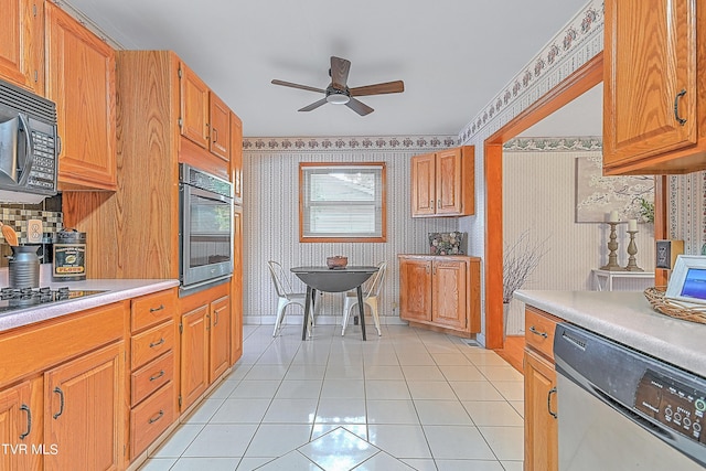 kitchen featuring wallpapered walls, light countertops, a ceiling fan, light tile patterned floors, and black appliances