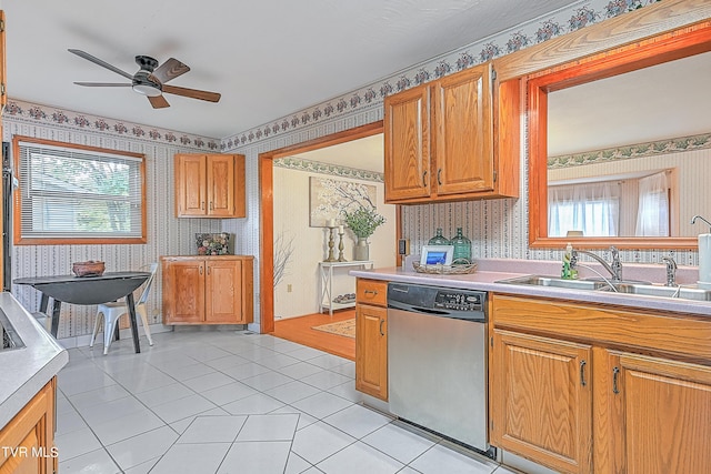 kitchen with wallpapered walls, light countertops, dishwasher, a ceiling fan, and light tile patterned floors