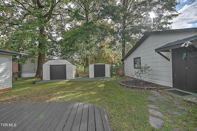 view of yard featuring an outdoor structure, a storage unit, and a wooden deck
