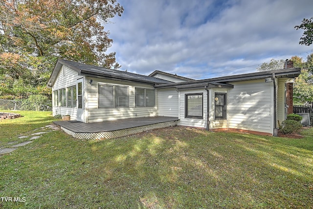 back of house with a lawn, fence, central AC unit, and a deck