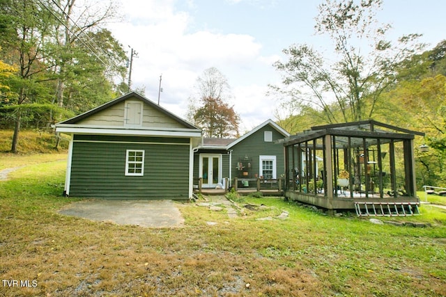 back of house with a wooden deck, a yard, and a patio