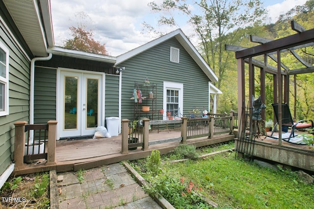 rear view of house featuring french doors and a deck