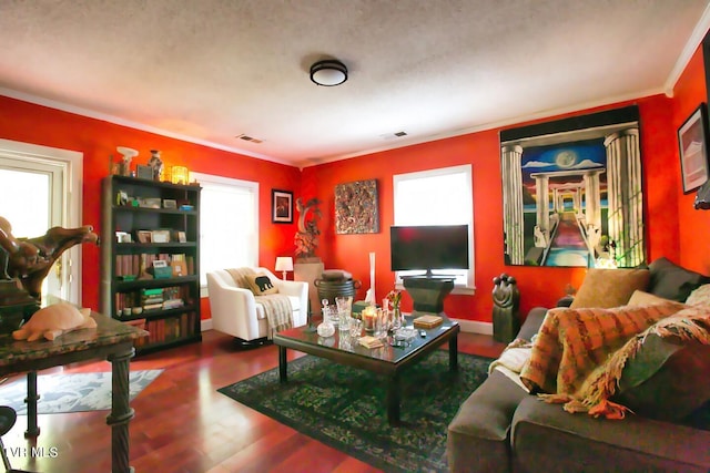 living room featuring crown molding, wood-type flooring, and plenty of natural light