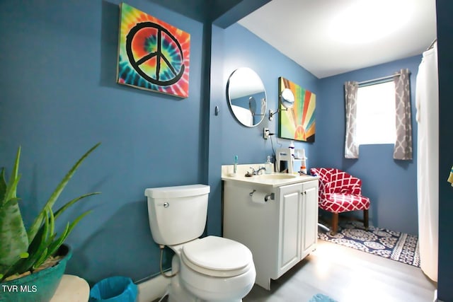 bathroom featuring vanity and toilet