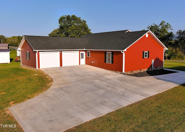 ranch-style house with a garage and a front lawn