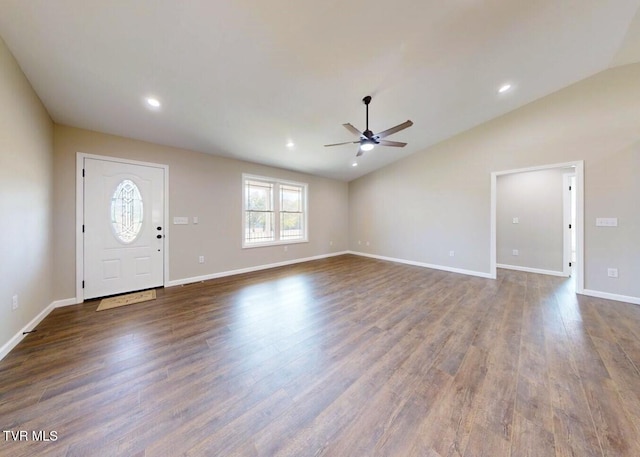 foyer entrance featuring dark hardwood / wood-style floors, ceiling fan, and vaulted ceiling