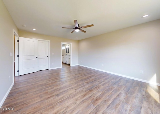 unfurnished bedroom featuring hardwood / wood-style flooring and ceiling fan