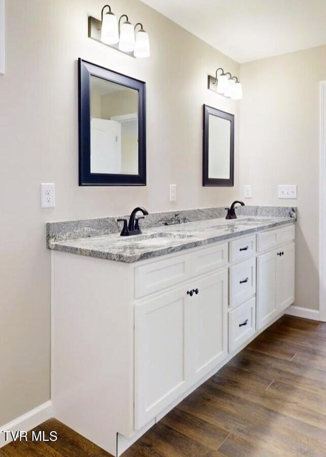 bathroom with vanity and wood-type flooring