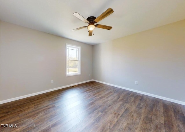 unfurnished room with ceiling fan and dark hardwood / wood-style flooring