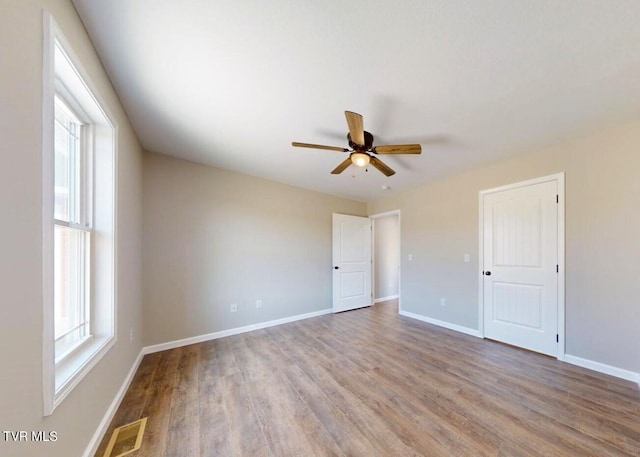 unfurnished room with hardwood / wood-style floors and ceiling fan