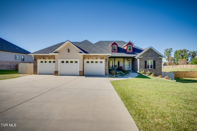 view of front of home with a front yard and a garage